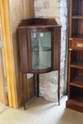 An Edwardian mahogany and inlaid and transfer decorated corner cupboard,