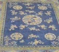 A Chinese carpet with all-over dragon decoration on a navy blue ground,