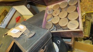 A vintage leather suitcase containing an assortment of various stamps, letters,