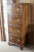 A walnut cross-banded narrow chest four deep drawers with applied moulding oval drop handles and