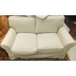 A modern OKA cream two seater sofa and a cream headboard