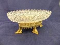 An early 19th Century cut glass fruit bowl on an early Victorian foliate pierced gilt metal stand