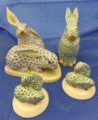 A Herend porcelain figure group of two rabbits decorated in blue on a white ground,