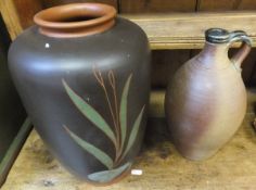 A collection of studio pottery wares to include large vase decorated with foliage on a brown ground,