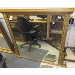 A Victorian oval gilt overmantel mirror and another similar gilt decorated mirror with moulded