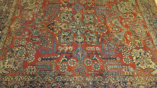 A Ziegler Mahal carpet, the terracotta ground with stylised floral and foliate motifs in blue,