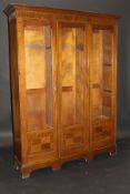 An Edwardian mahogany and satinwood strung three section bookcase,