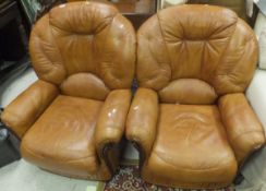 A pair of modern light tan / brown armchairs