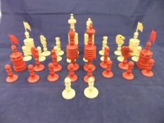 A 19th Century carved bone and red-stained bone chess set with two spare white pawns