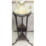 A mahogany circular wash stand with miniature pottery jug and bowl,