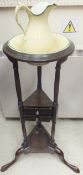 A mahogany circular wash stand with miniature pottery jug and bowl,