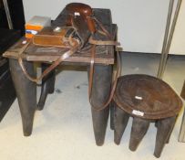 A Nupe carved hardwood stool, the rectangular top on four tapered legs united by stretchers,