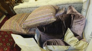 Two boxes of assorted scatter cushions in purple hues with co-ordinating striped cushions