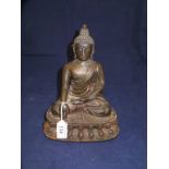 A late 17th / early 18th Century Sino-Tibetan bronze figure of a seated Buddha CONDITION
