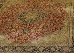 An Iranian Kashan carpet, the central floral medallion in cream, blue, green, gold and salmon,