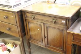 An Edwardian mahogany side cupboard, the rectangular top over a single drawer,