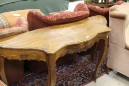 A 19th Century French walnut shaped side table with floral carved decoration,