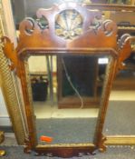 A walnut fretwork carved wall mirror in the early 18th Century manner