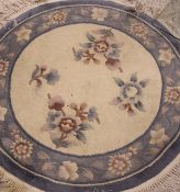 A Chinese superwash circular rug on a cream ground,