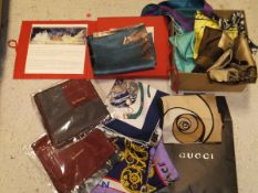 A box containing a Gucci silk scarf in a brown Gucci envelope,