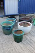 Nine various glazed garden plant pots to include two in a mottled brown glaze with ribbed sides,