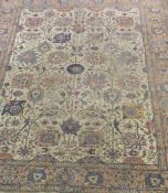 A Tabriz carpet with all-over foliate decoration in reds, blues and pinks on a cream ground,