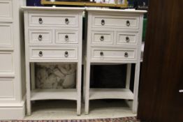 A pair of white painted four-drawer bedside cabinets,