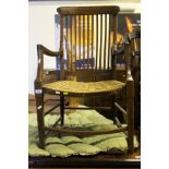 A beech and elm framed carver chair with rush seat,