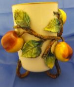 An early to mid 20th Century cylindrical pottery vase decorated in high relief with three apples