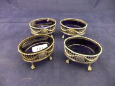 A set of four George III silver and pierced oval open salts on claw and ball feet (London 1773 by