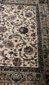 A Middle Eastern rug, the cream ground with all-over foliate decoration,