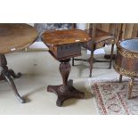 A 19th Century rosewood sewing table, the shaped top opening to reveal a fitted interior,