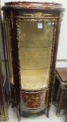 A reproduction mahogany and brass mounted bow fronted vitrine in the Louis XV manner,