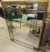 A gilt overmantel mirror with bevelled edge and moulded decoration and another gilt and blue