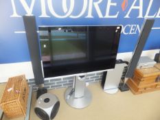 A Bang & Olufsen flatscreen pedestal television, pair of pedestal line speakers, CD player,