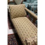 A Victorian mahogany framed chaise longue upholstered in cream ground foliate fabric