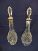 A graduated matched pair of cut glass mallet shaped decanters with silver rims (Sheffield 1987,