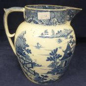 A large early 19th Century blue and white transfer decorated jug and a cast iron doorstop in the