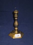 An 18th Century brass candlestick of hexagonal form