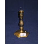 An 18th Century brass candlestick of hexagonal form