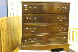 A reproduction mahogany chest of four graduated drawers on bracket feet and an Indian hardwood