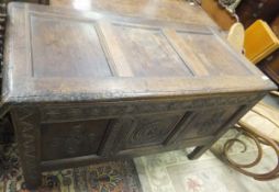 A 17th Century (circa 1630-50) oak coffer, the three panel top with moulded stiles,