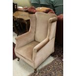 A 19th Century wing back arm chair with salmon pink upholstery