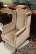 A 19th Century wing back arm chair with salmon pink upholstery