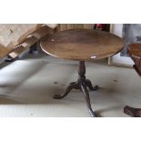 A Victorian oak tilt-top table,