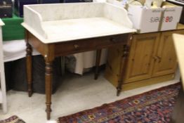 A 19th Century marble topped mahogany wash stand, the galleried top above two drawers,