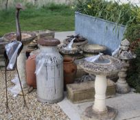 A collection of garden ornaments and statues to include composite garden urns, milk churn,