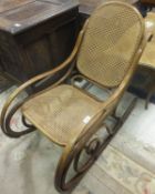 A circa 1900 bentwood and caned rocking arm chair after the original design by Michel Thonet