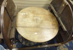 A 19th Century oak oval snap top table,