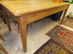 A rectangular pine dining table raised on straight cut square sectioned legs